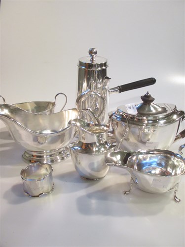 Lot 201 - A three piece silver tea set, a silver sauce...
