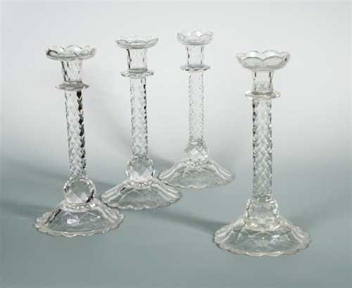 Lot 53 - A matched set of four cut glass candlesticks