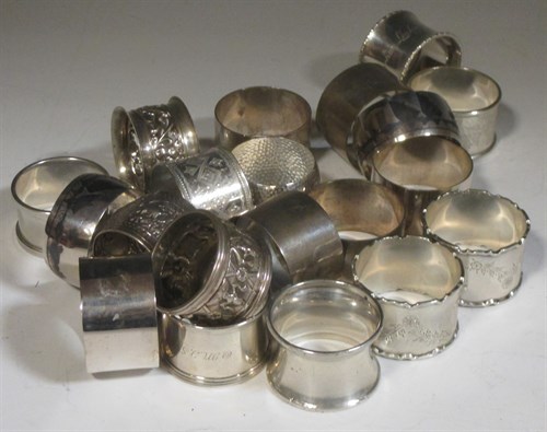 Lot 184 - A collection of twelve napkin rings of silver...