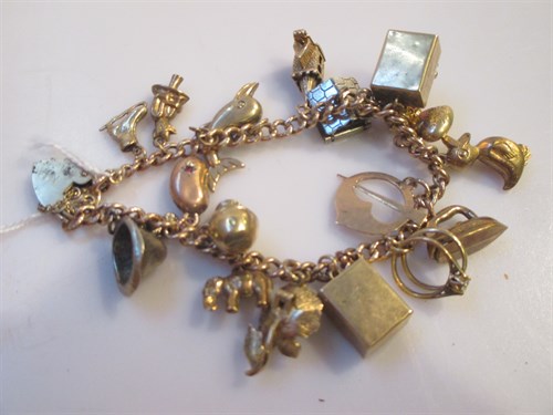 Lot 158 - A 9ct gold charm bracelet with charms 42.5g