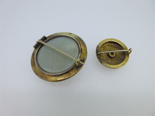Lot 245 - Two circular Victorian gem set brooches - one coral, one with a garnet and diamond flower