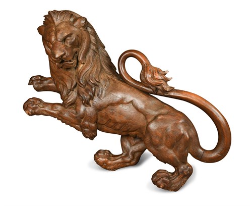 Lot 327 - A large carved wood wall mounted figure of a lion