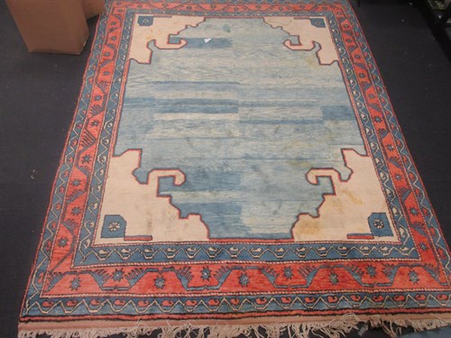 Lot 576 - A 20th century cream ground rug with red and...