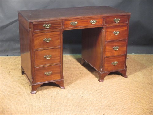 Lot 371 - A George III style mahogany kneehole desk with...