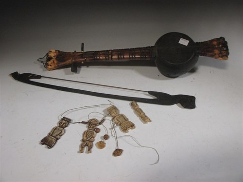 Lot 47 - Bone tribal figures and a tribal instrument...