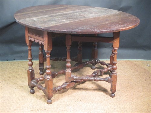 Lot 370 - A 17th century oval gateleg drop leaf table...