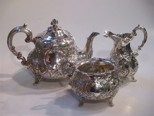Lot 214 - A Victorian harlequin repousse three piece...