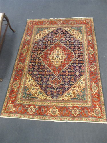 Lot 432 - A red ground Tabriz 190 x 135cm