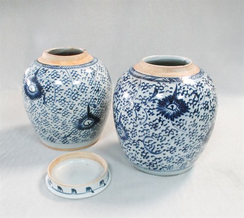 Lot 82 - A pair of provincial blue and white jars with covers, 19th century