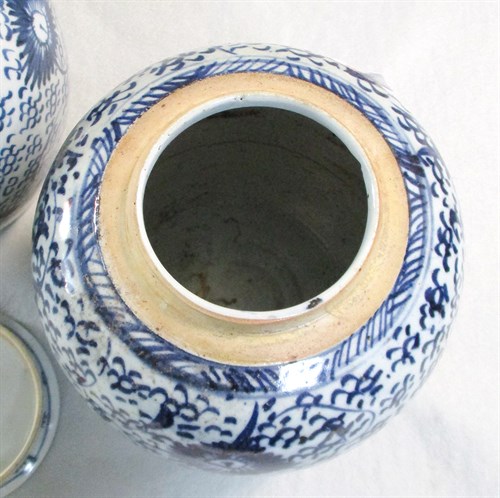 Lot 82 - A pair of provincial blue and white jars with covers, 19th century