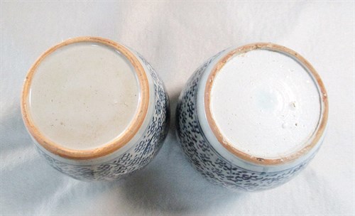 Lot 82 - A pair of provincial blue and white jars with covers, 19th century