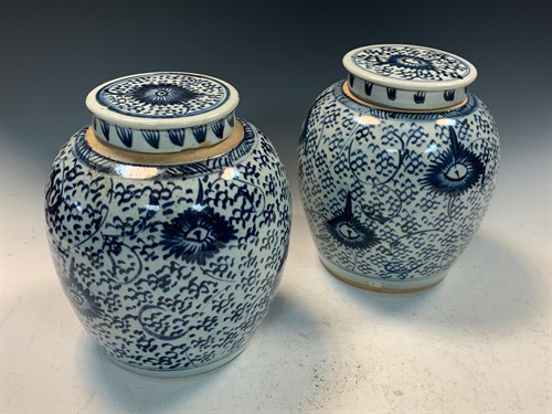 Lot 82 - A pair of provincial blue and white jars with covers, 19th century