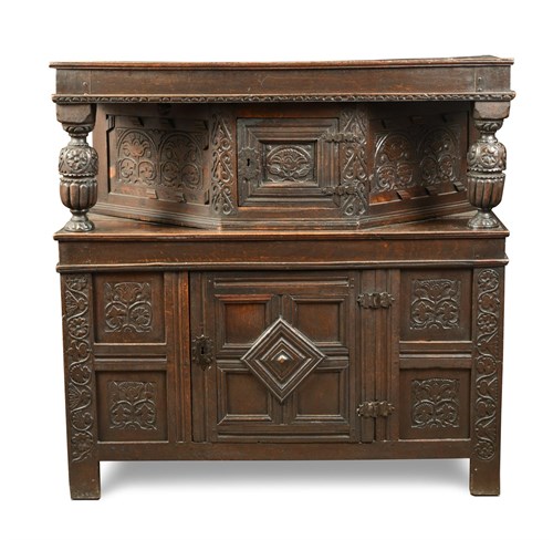 Lot 383 - An early 17th century Jacobean carved oak court cupboard