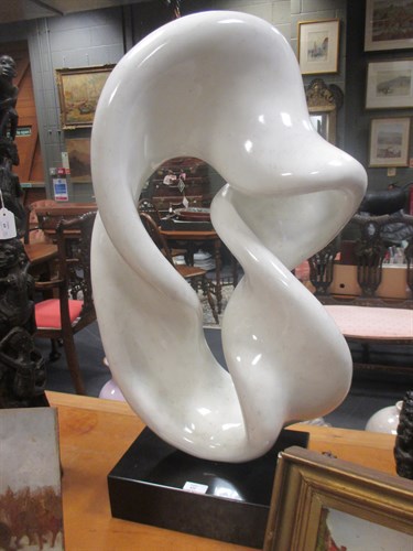 Lot 425 - A modern fibrelass abstract sculpture on a...