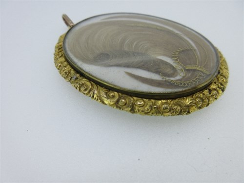Lot 332 - An early Victorian double-sided pendant with a portrait miniature front and hairwork back