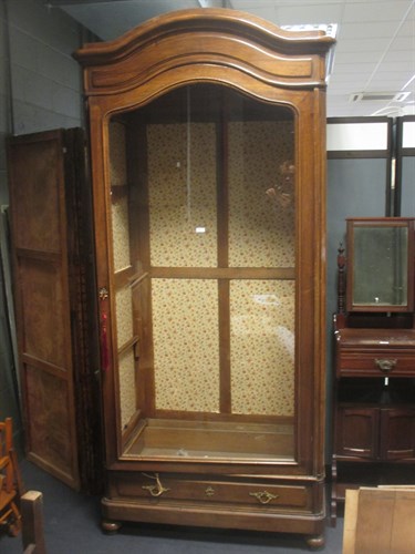 Lot 529 - A continental walnut single door armoire, 240...
