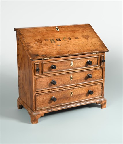 Lot 319 - A late Georgian walnut and inlaid miniature bureau