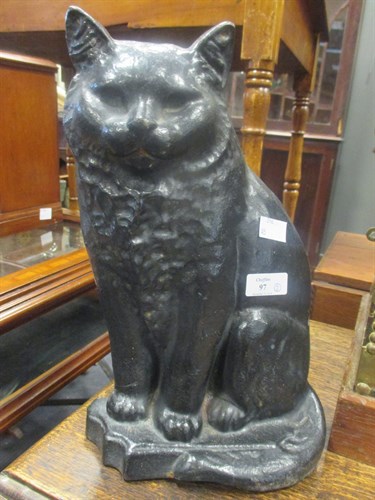 Lot 97 - A Victorian black painted iron seated cat...
