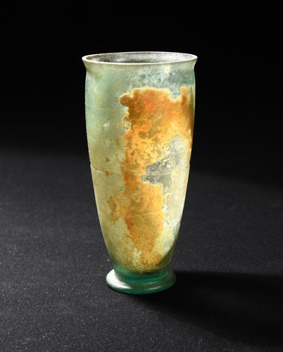 Lot 266 - A Roman iridescent glass beaker, 1st century AD