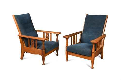 Lot 103 - A pair of Arts and Crafts oak framed reclining chairs, possibly by Shapland & Petter