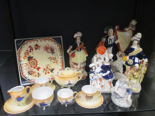Lot 50 - Five Staffordshire figures, including a man...