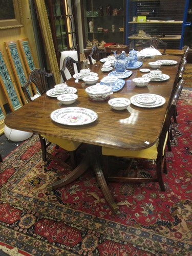 Lot 394 - A mahogany extending dining table with two...