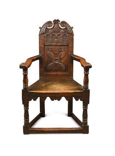 Lot 381 - An early 17th century oak 'cacqueteuse' joined armchair