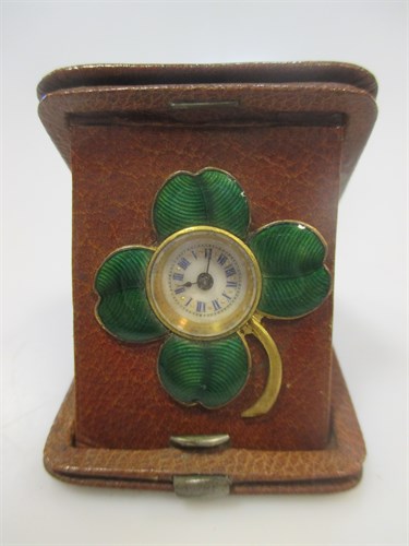 Lot 174 - A leather cased travelling timepiece with four...