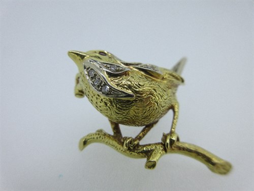 Lot 421 - An 18ct yellow and white gold ruby and diamond set wren brooch by Cropp & Farr