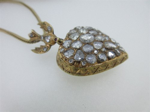 Lot 336 - A diamond set St Esprit pendant on a gold foxtail link chain