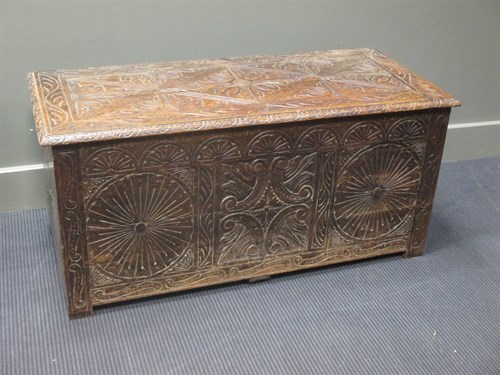 Lot 468 - An oak coffer with carved panels 50 x 105 x 46cm