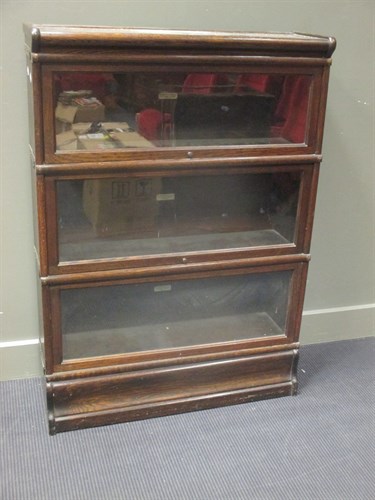 Lot 431 - A three section oak Globe Wernike bookcase,...