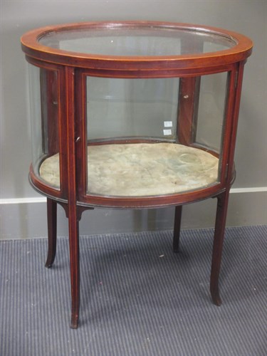 Lot 490 - An Edwardian mahogany and glass oval...
