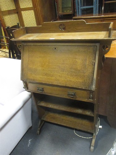 Lot 561 - An oak Arts & Crafts desk together with three...