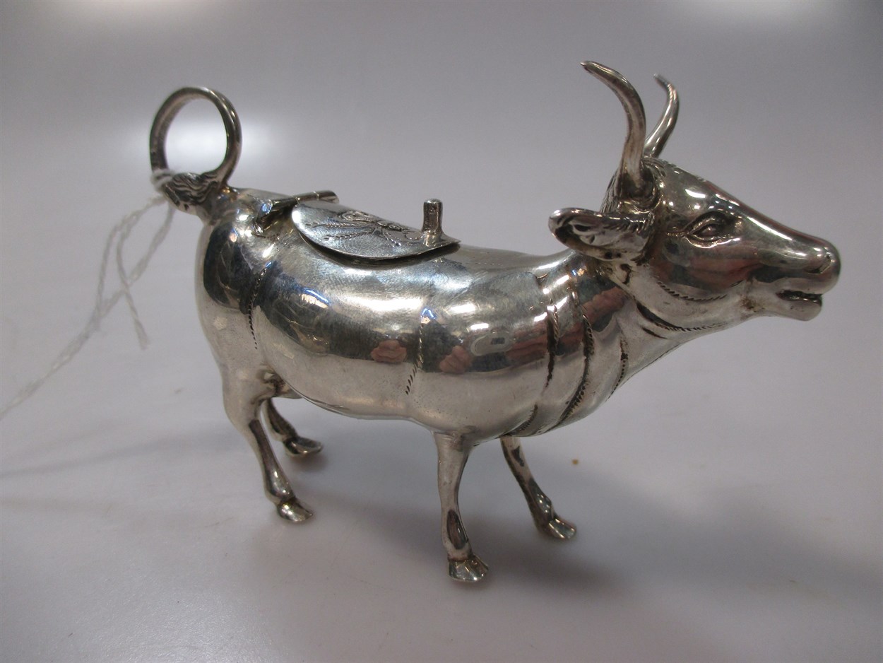 Lot 228 - A Continental silver cow creamer with hinged...