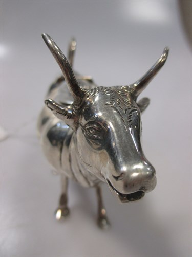 Lot 228 - A Continental silver cow creamer with hinged...