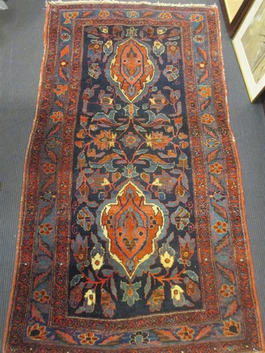 Lot 442 - A red ground rug, 207 x 110cm