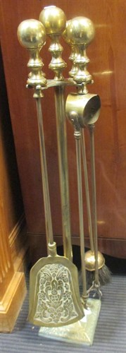 Lot 281 - A set of brass fire irons on a stand