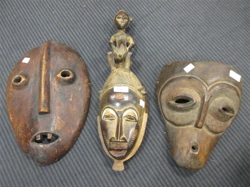 Lot 73 - Tribal carvings and figures: 3 masks, stool, 2...