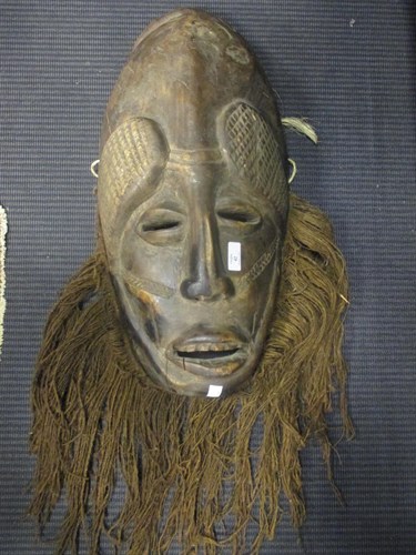 Lot 42 - An African tribal bearded mask, 55cm high, and...