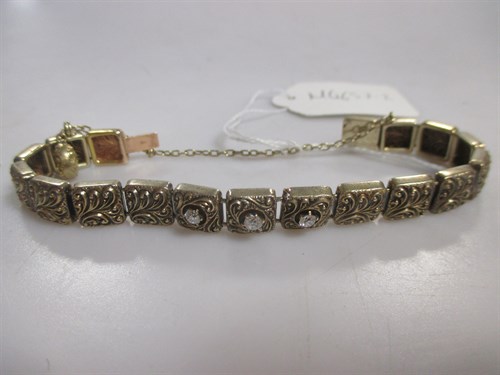 Lot 178 - An unhallmarked yellow metal fancy square link...