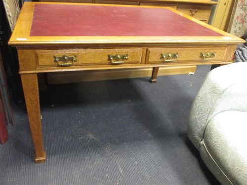 Lot 390 - A late 19th century oak three drawer writing...