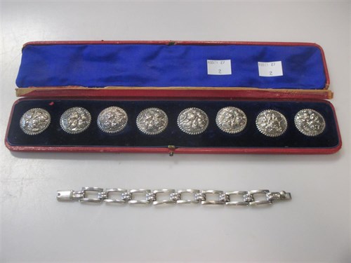 Lot 146 - A cased set of eight silver buttons and a...