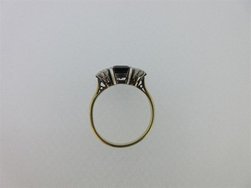 Lot 432 - A sapphire and diamond three stone ring