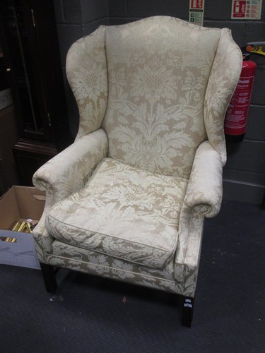 Lot 380 - A George III style wing back armchair of large...
