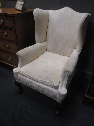 Lot 331 - A George III style wing back arm chair on claw...