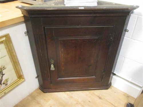 Lot 408 - An oak corner cupboard with single fielded...
