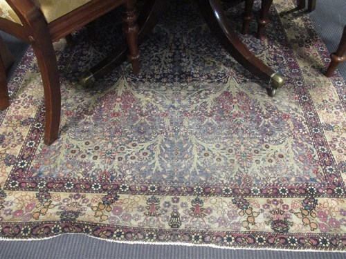 Lot 437 - A red and blue floral pattern rug with white...