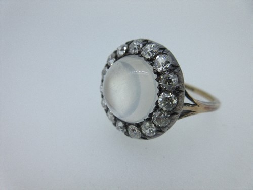 Lot 323 - A moonstone and diamond cluster ring