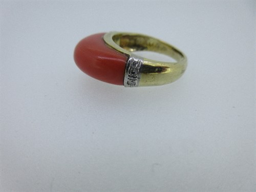 Lot 243 - A coral and diamond dress ring